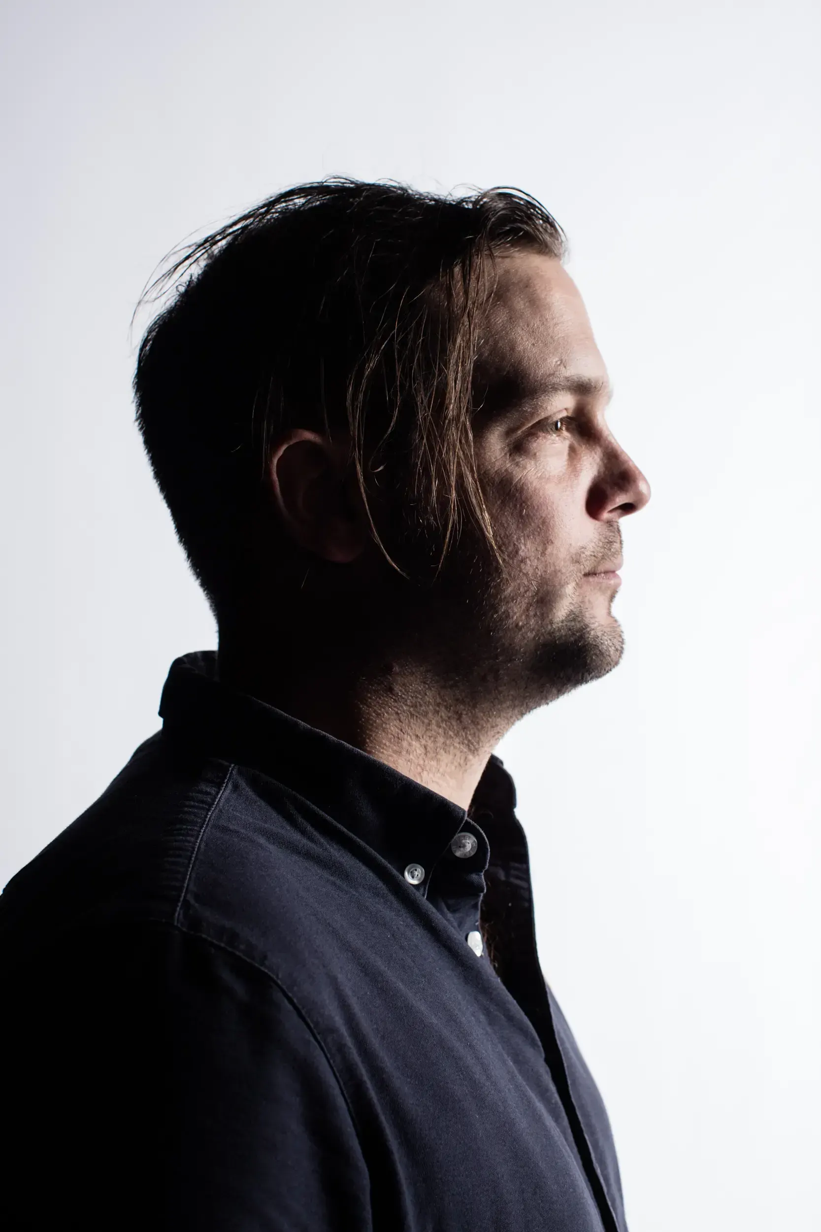 Studio profile portrait of André Willmund against a white background.