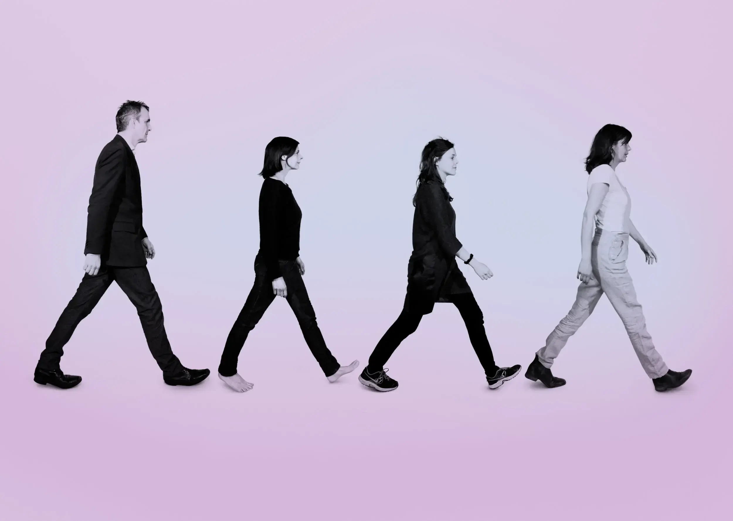 Theatre ensemble recreating the Beatles' Abbey Road album cover, four people walking in a row.