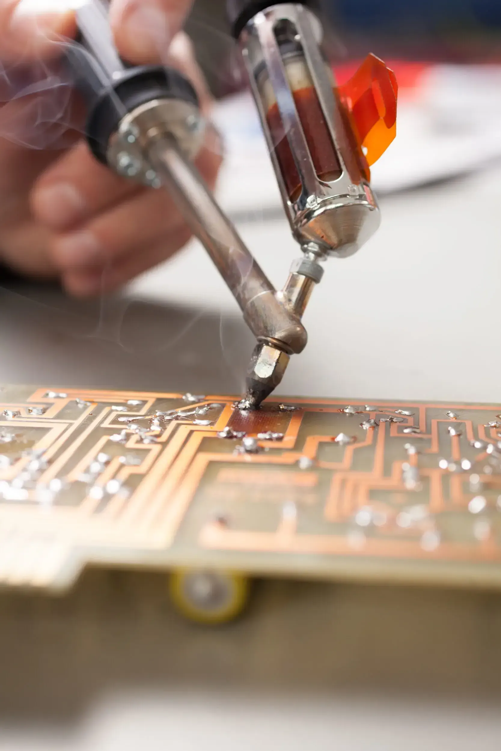 Close-up of a circuit board being soldered at Greiner Vibrograf.
