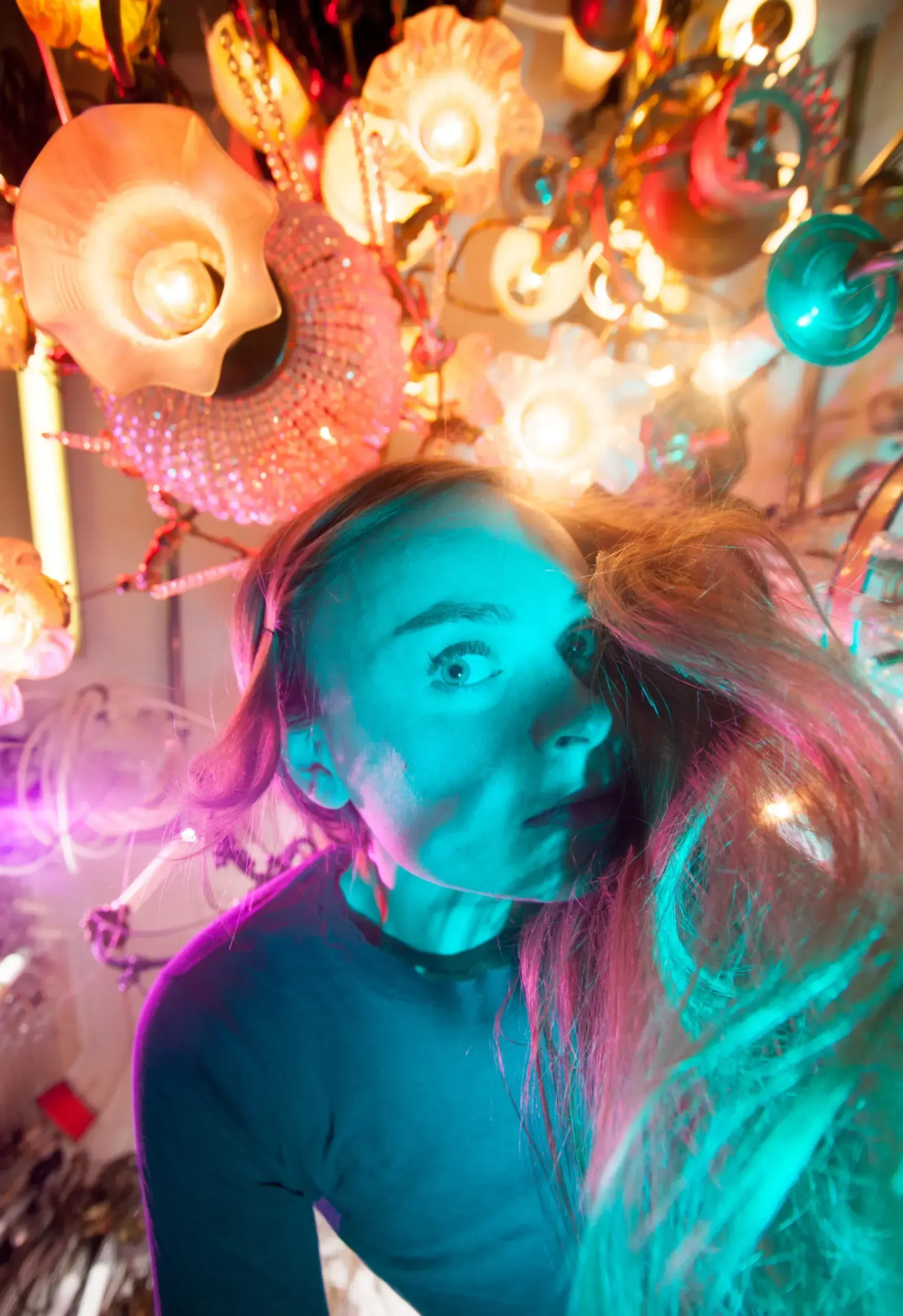 Portrait of actress Henrike Jörissen surrounded by colorful glowing ornaments and lights.