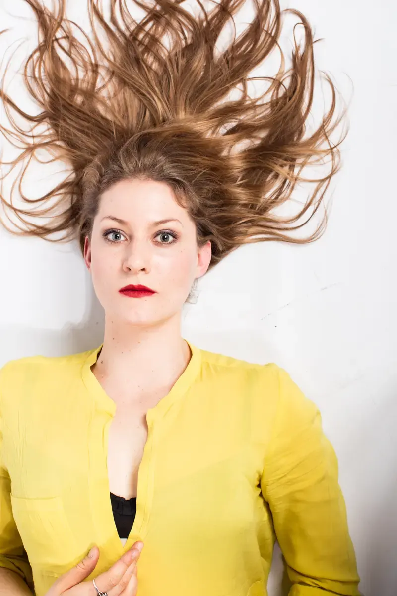 Portrait von Lisa-Katrina Mayer mit fliegendem Haar, liegende Pose