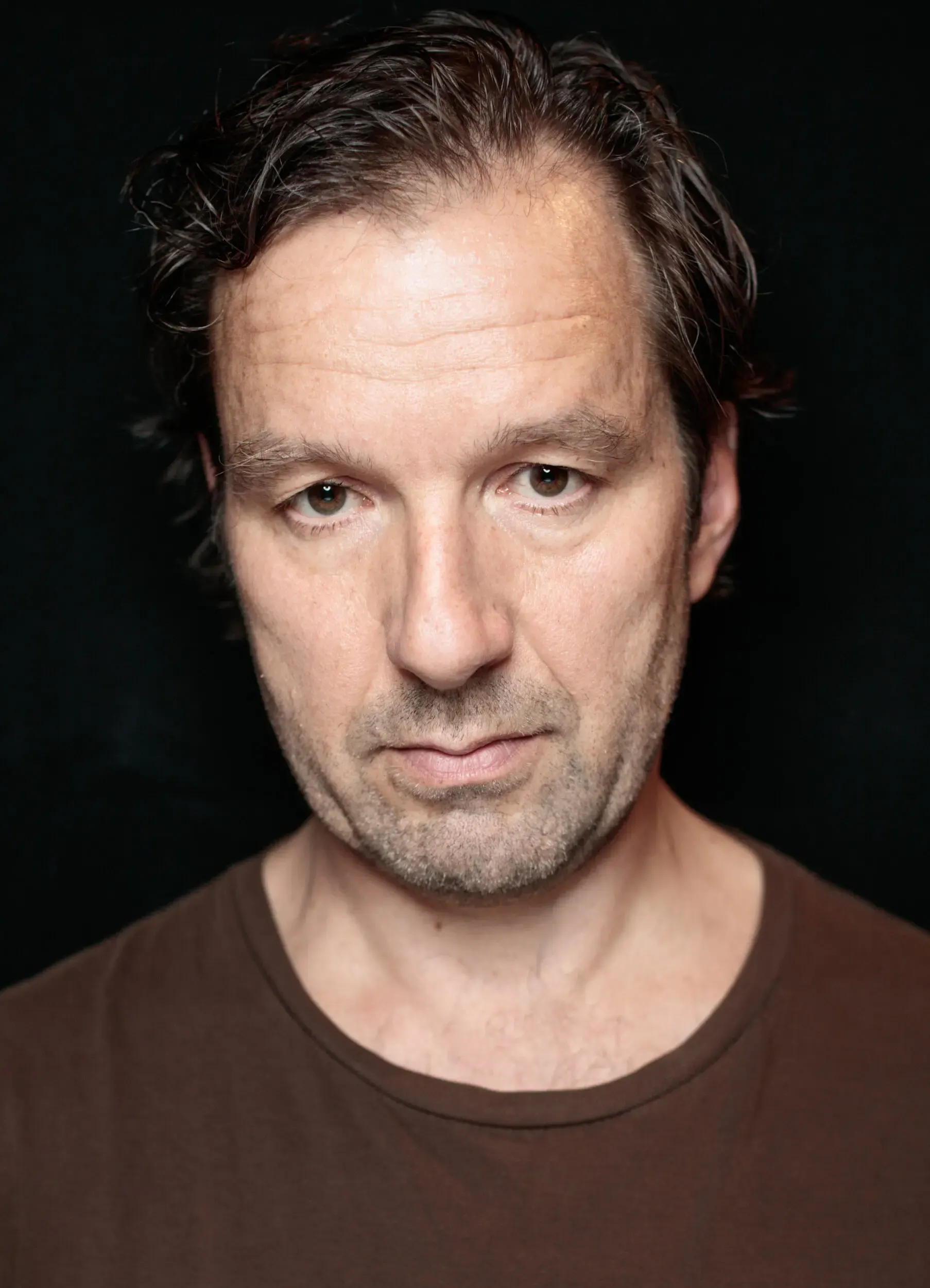 Portrait von Michael Neuenschwander in braunem Pullover