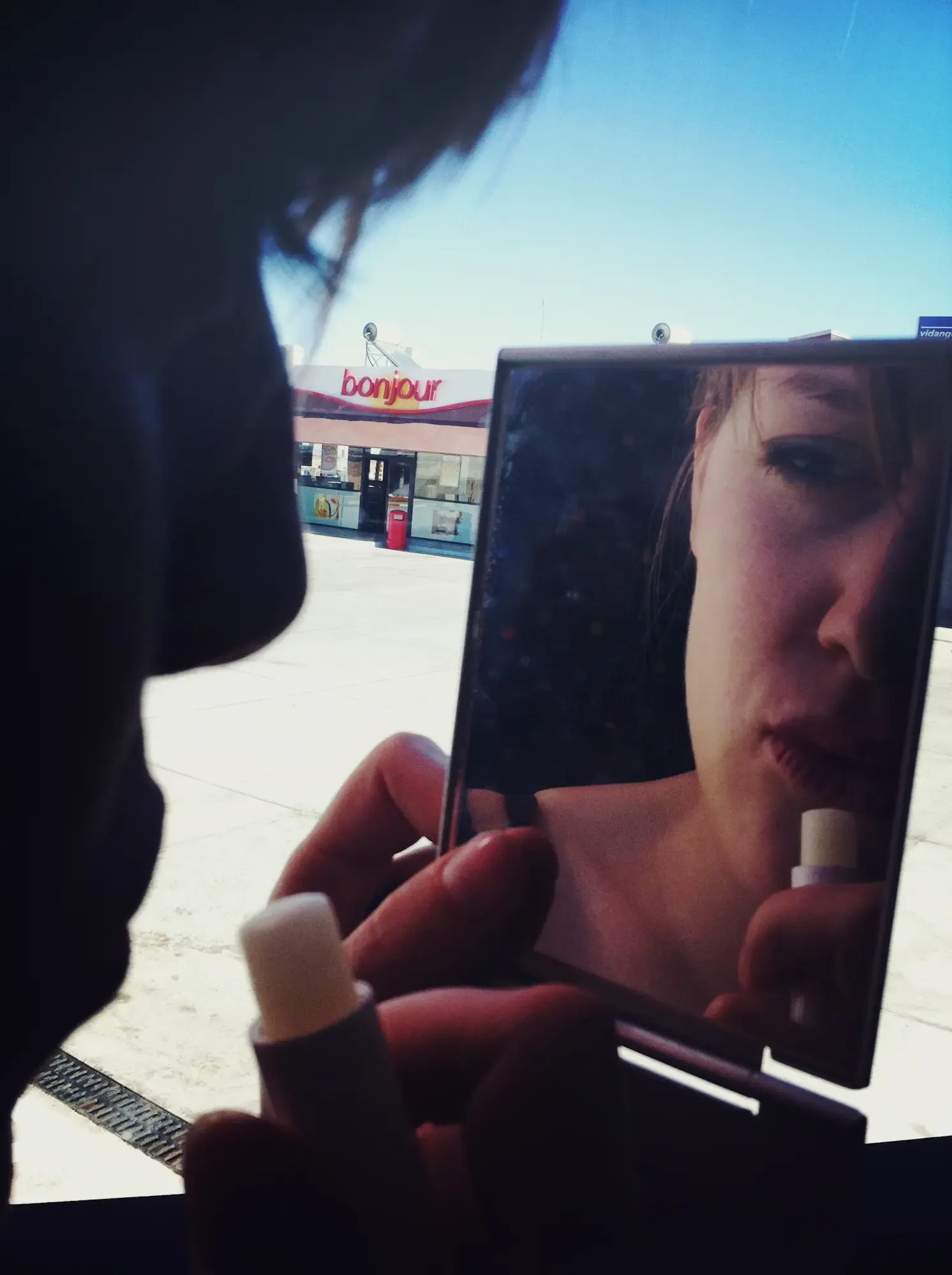 Nahaufnahme einer Frau beim Lippenpflege-Auftragen im Spiegel, Morocco Experience